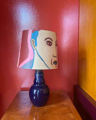 Ceramic glazed blue table lamp with art on top!