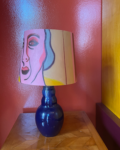 Ceramic glazed blue table lamp with art on top!
